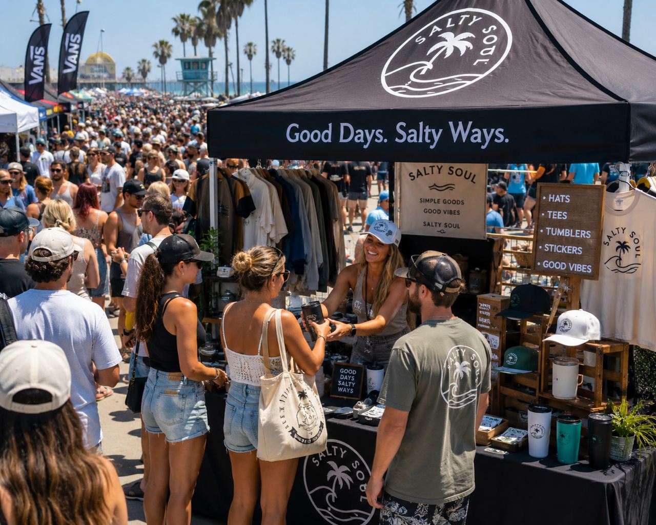 A busy vendor booth at a packed beach event